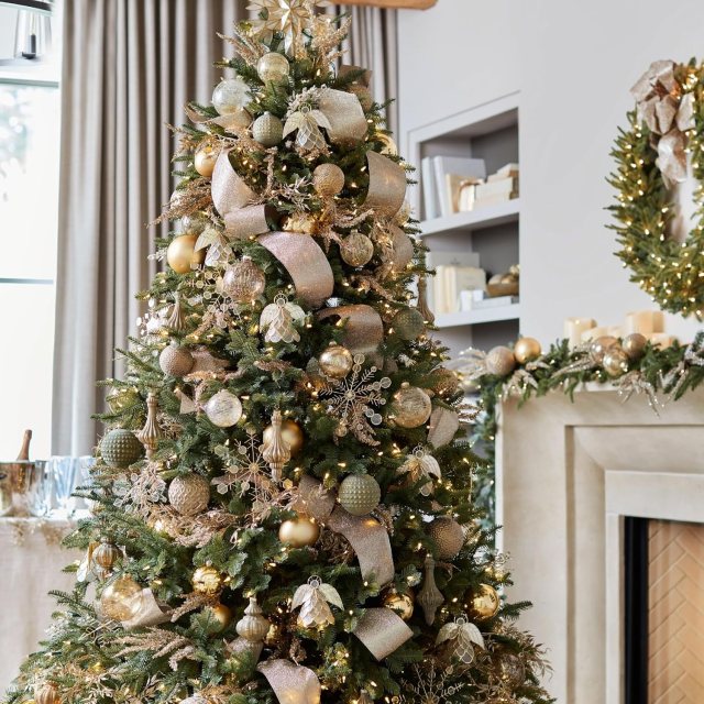 Balsam Hill BH Balsam Fir full artificial Christmas tree decorated with gold ribbon, ornaments and warm Christmas lights